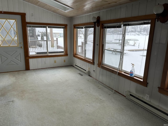 unfurnished sunroom featuring wood ceiling, vaulted ceiling, and a baseboard heating unit