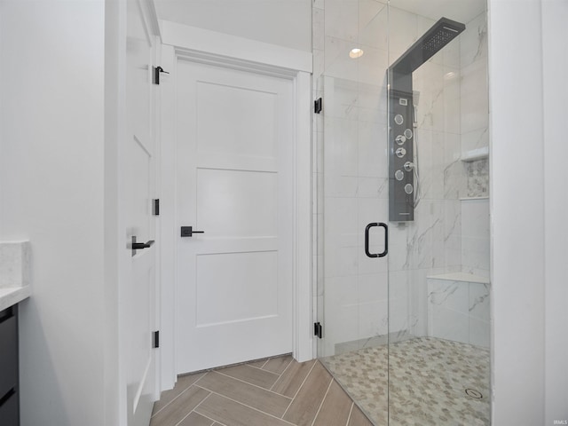 bathroom with a shower with door