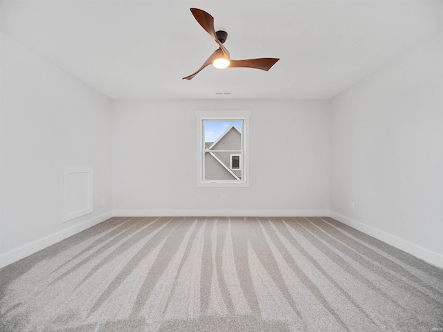 empty room featuring ceiling fan and carpet floors