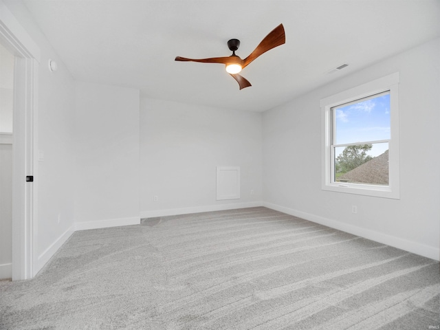 carpeted empty room featuring ceiling fan