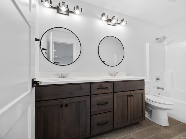 full bathroom with toilet, vanity, and bathing tub / shower combination