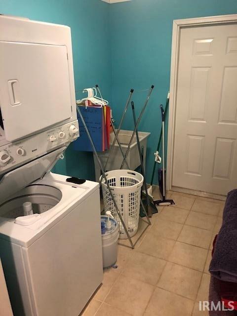 2893 S US Route 31, Peru, IN 46970 - laundry room featuring light tile patterned floors and stacked washing maching and dryer