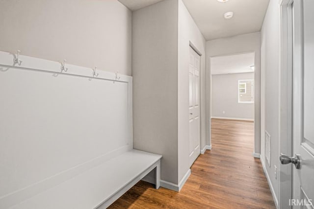 mudroom with baseboards and wood finished floors