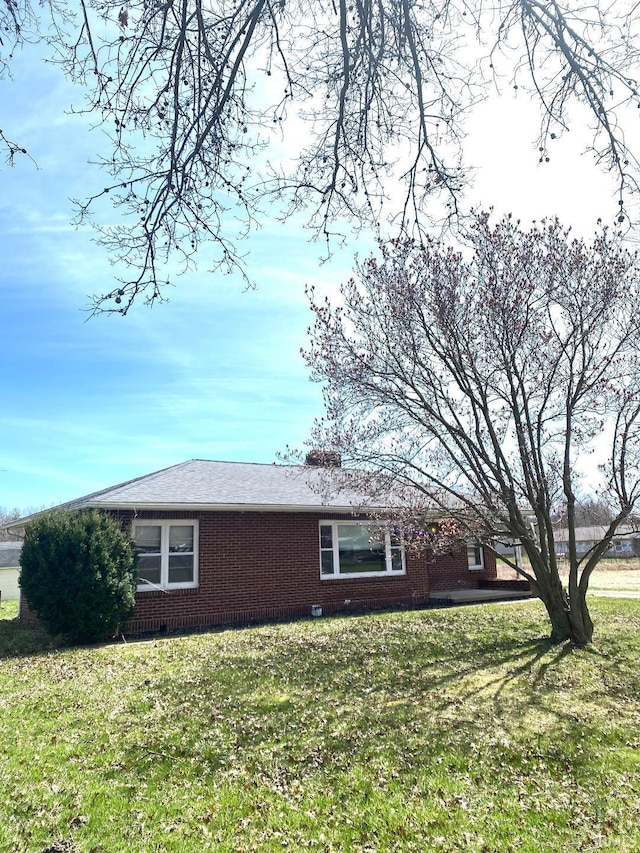 view of side of property with a yard