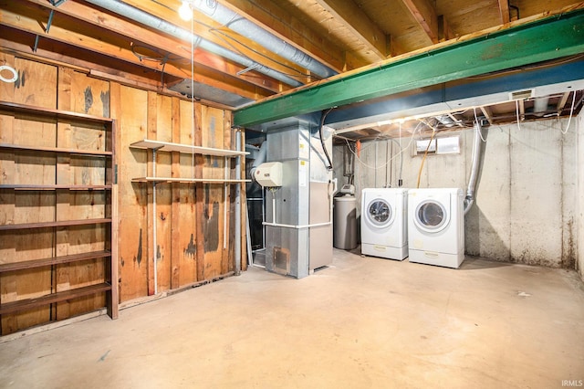 basement featuring separate washer and dryer and heating unit