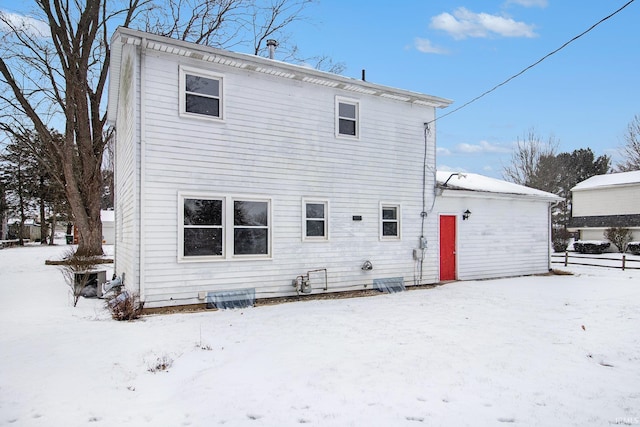 view of snow covered rear of property