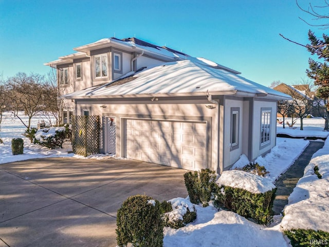 view of snowy exterior with a garage