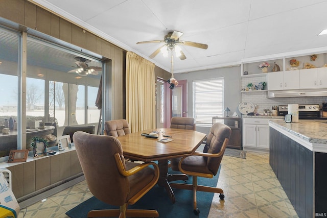 dining area featuring ceiling fan and crown molding