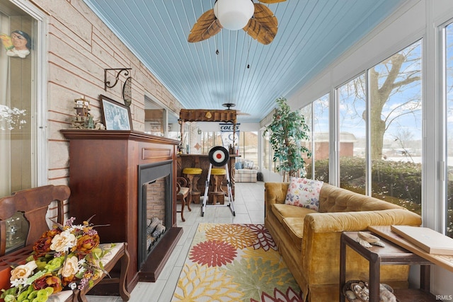 sunroom featuring ceiling fan