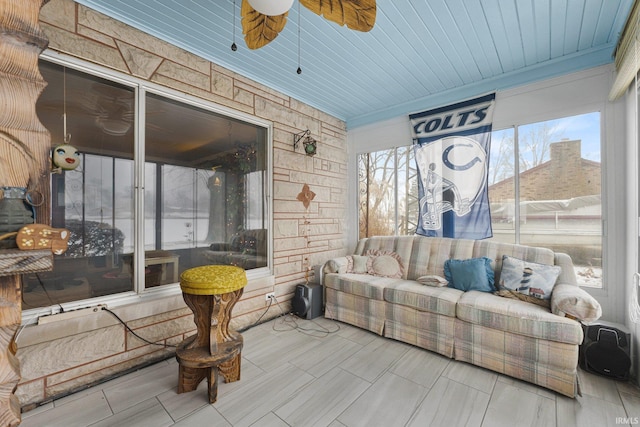 sunroom / solarium with ceiling fan and wood ceiling