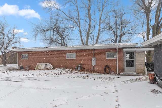 view of snow covered rear of property