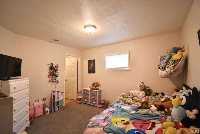 bedroom with dark colored carpet and a textured ceiling