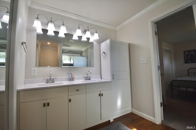 bathroom featuring vanity, wood-type flooring, and ornamental molding