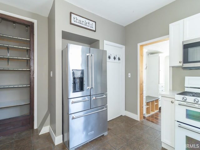 kitchen with stainless steel appliances and white cabinetry