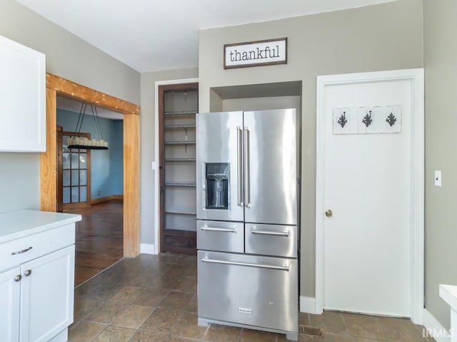 kitchen with white cabinetry and high end refrigerator