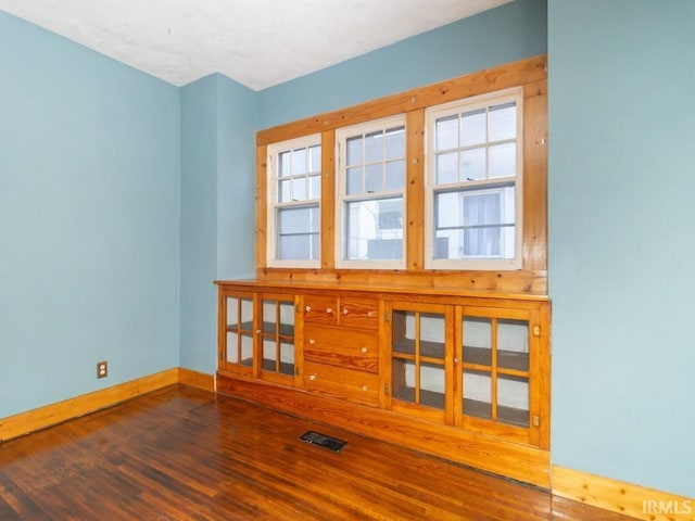 spare room with dark wood-type flooring