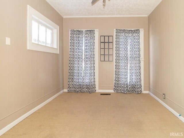 carpeted empty room with crown molding