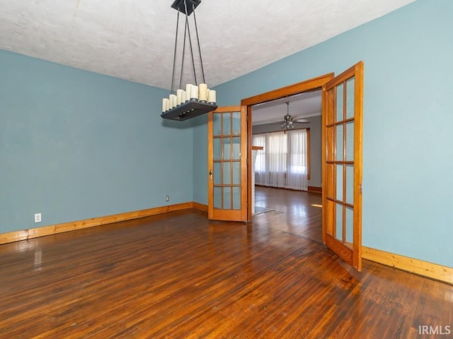 unfurnished room featuring ceiling fan, french doors, a textured ceiling, and dark hardwood / wood-style floors