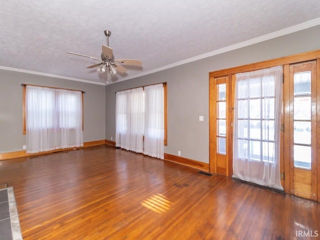 unfurnished room featuring a textured ceiling, ceiling fan, crown molding, and dark hardwood / wood-style floors