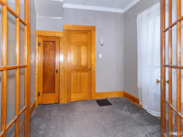 carpeted empty room with french doors and ornamental molding