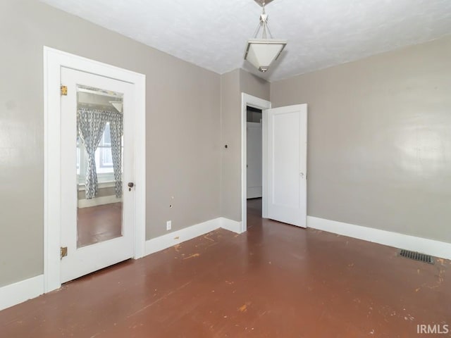 spare room with a textured ceiling