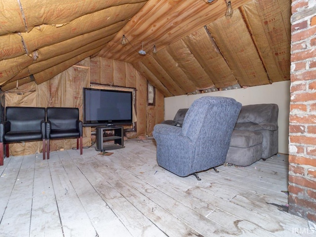 interior space with hardwood / wood-style floors and lofted ceiling