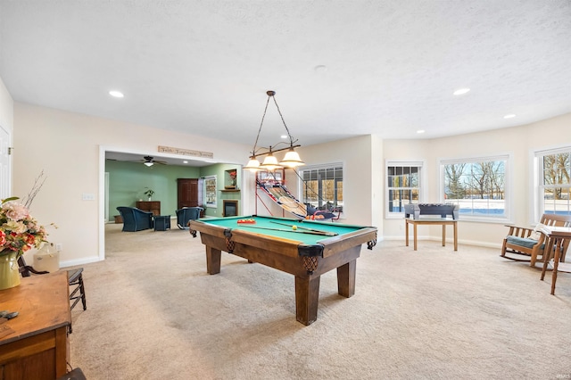 rec room featuring pool table, light colored carpet, ceiling fan, and a textured ceiling