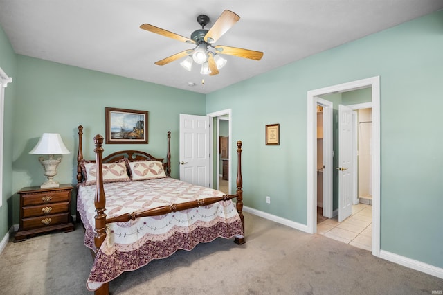 bedroom featuring ensuite bath, ceiling fan, and light carpet