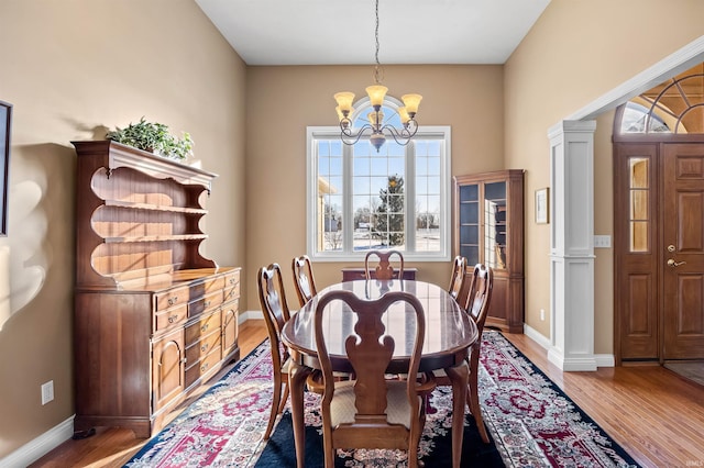 dining area featuring an inviting chandelier and wood-type flooring