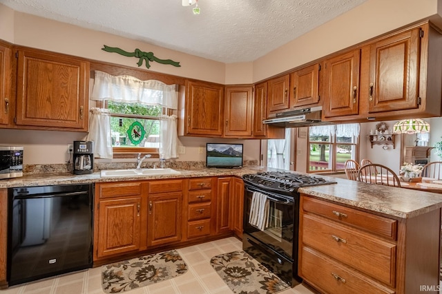 kitchen featuring sink, a textured ceiling, black appliances, and kitchen peninsula