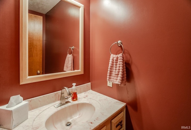 bathroom with vanity and a textured ceiling