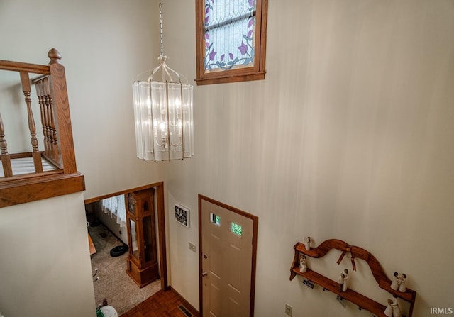 foyer entrance featuring an inviting chandelier and dark parquet floors