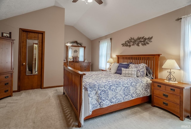 carpeted bedroom featuring multiple windows, ceiling fan, and vaulted ceiling