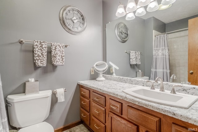 bathroom with toilet, curtained shower, and vanity