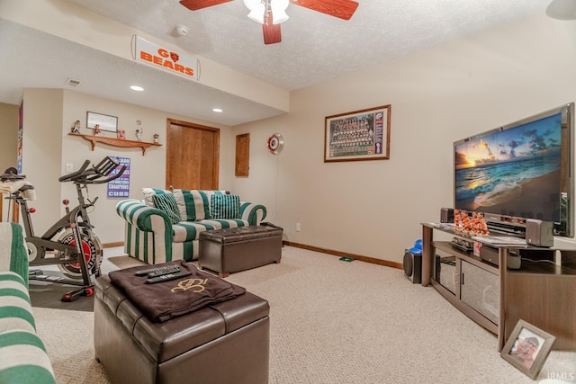 carpeted living room featuring a textured ceiling and ceiling fan