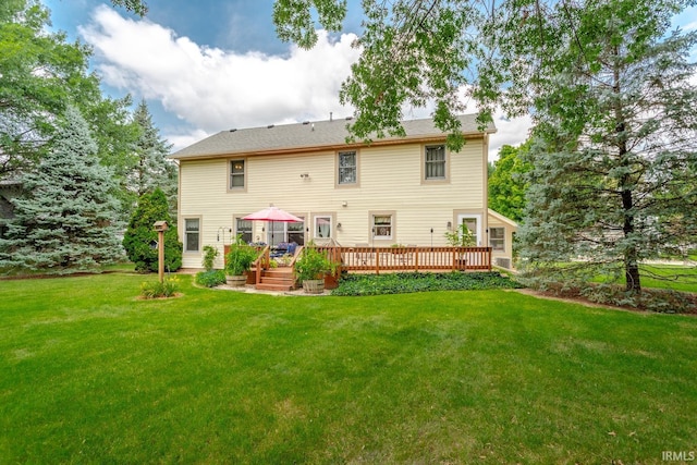 back of property featuring a yard and a wooden deck