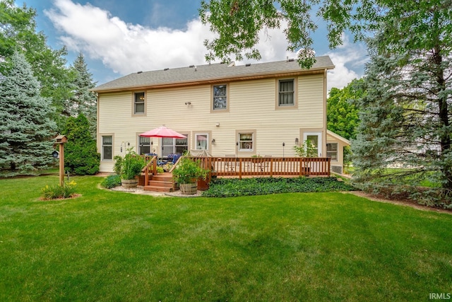 back of house with a deck and a yard