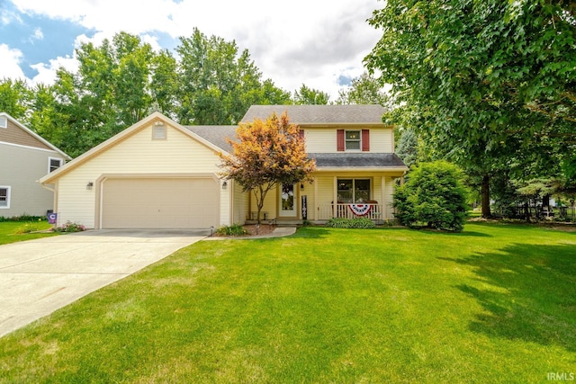 view of front of home with a front yard, a garage, and covered porch