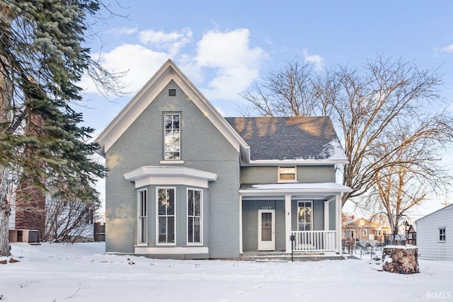 snow covered house with covered porch