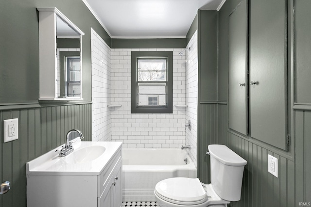 bathroom with a tub to relax in, crown molding, vanity, and toilet