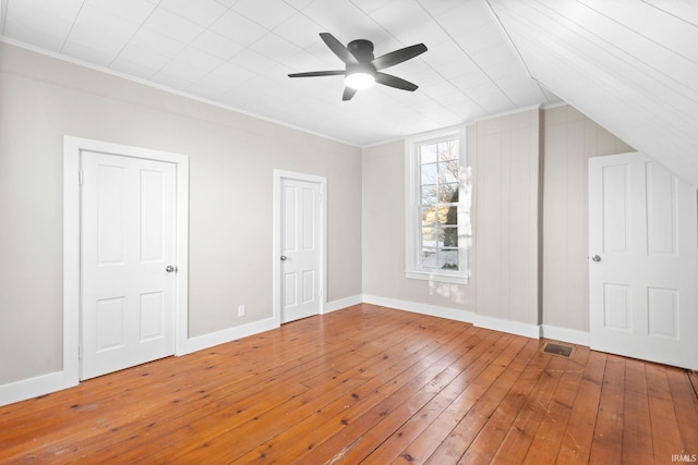 bonus room with ceiling fan and hardwood / wood-style floors