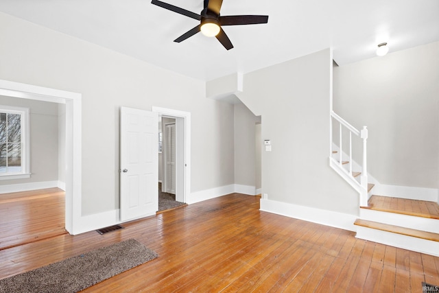 unfurnished living room featuring ceiling fan and wood-type flooring