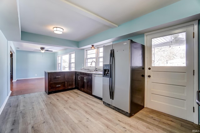 kitchen with ceiling fan, appliances with stainless steel finishes, light hardwood / wood-style floors, and sink