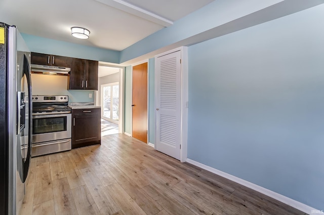 kitchen with appliances with stainless steel finishes, beamed ceiling, light hardwood / wood-style floors, and dark brown cabinetry