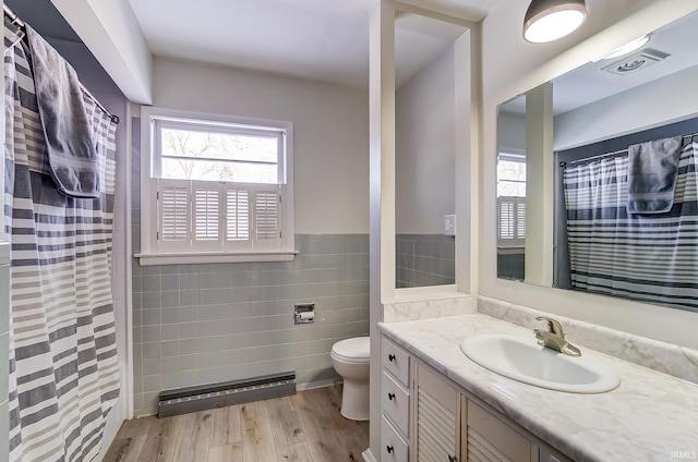 bathroom featuring vanity, tile walls, toilet, walk in shower, and hardwood / wood-style flooring