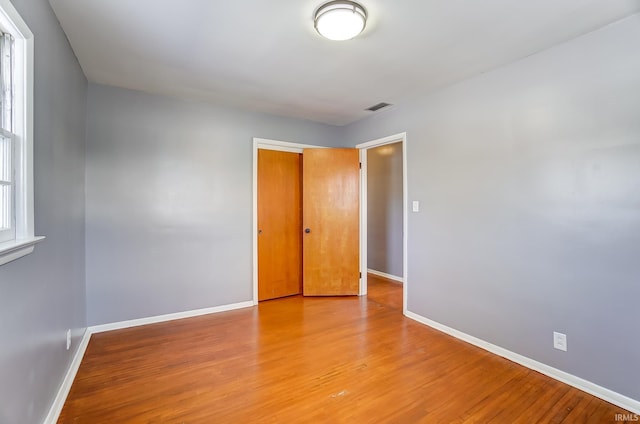 unfurnished room with light wood-type flooring