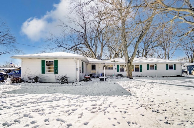 view of snow covered back of property