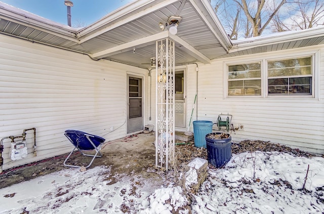 view of snow covered property entrance