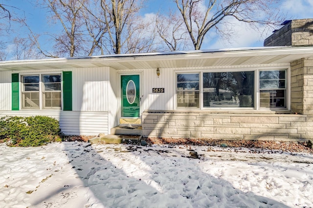 view of snow covered property entrance