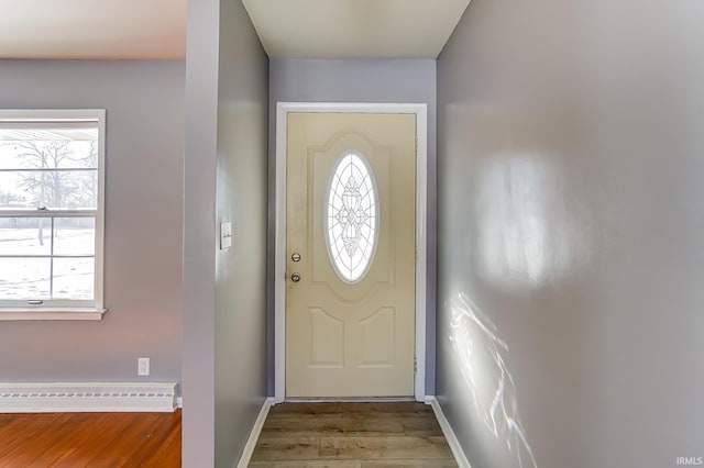 doorway to outside featuring hardwood / wood-style floors and a baseboard radiator